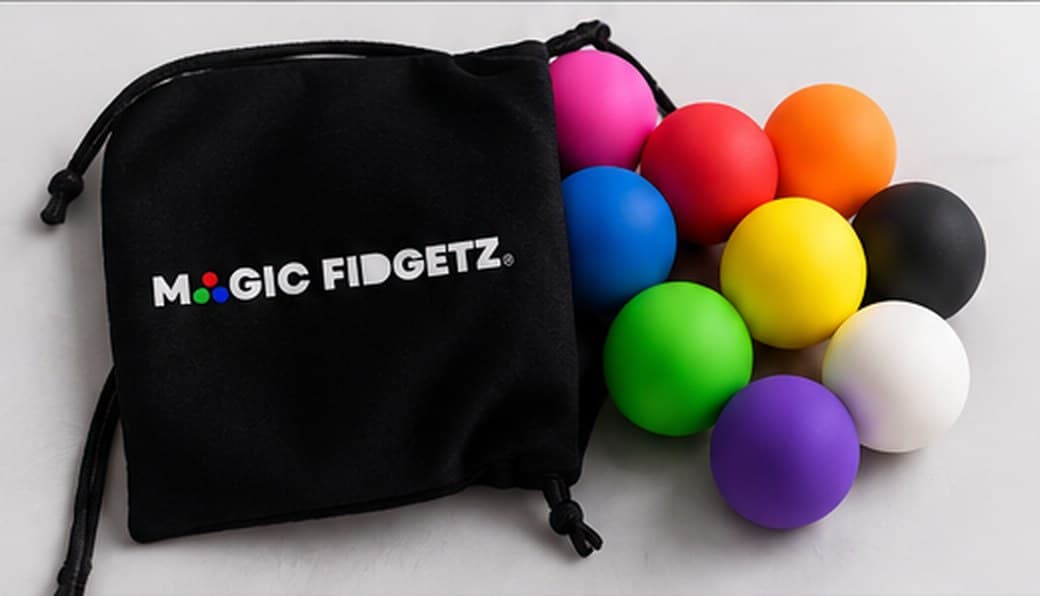 Magic Fidgetz balls spilling from a black drawstring pouch printed with the Magic Fidgetz logo